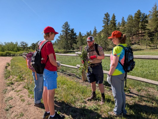 Interpretive-Ranger-Educating-group-on-the-plant