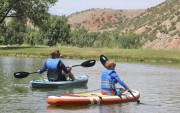Visitors paddleboarding at Hot Spring State Park